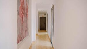 a hallway with a door leading to a room with paintings at Khách sạn Trọng Thiêm 2 in Bảo Lộc