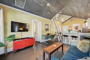 a living room with a couch and a table and a kitchen at Peaceful Bungalow with Fenced Yard near Shops and Cafes in Austin