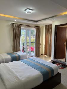 Una cama o camas en una habitación de Nagarkot Resort PVt. Ltd