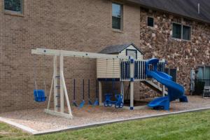 a playground with a slide in front of a building at The Mountain Lodge in Elliottsburg