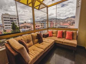 a large couch in a room with a large window at Gran Kunturwasi Hotel Senior in Cajamarca