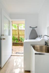 a kitchen with a sink and a door to a yard at Growder Court 3 - Coolum Beach QLD in Coolum Beach