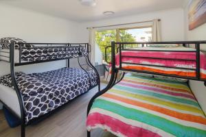 a bedroom with two bunk beds and a window at Growder Court 3 - Coolum Beach QLD in Coolum Beach