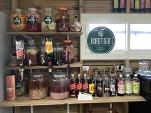 a shelf filled with jars of food and drinks at LES AGAPANTHES du 27 -ème in Le Tampon