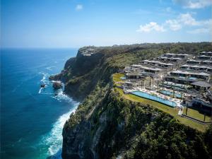 an aerial view of a resort on a cliff next to the ocean at Six Senses Uluwatu in Uluwatu