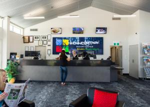 a woman standing at a counter in an office at Kennedy Park Resort Napier in Napier