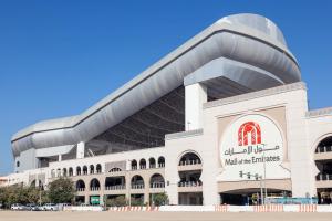 a large white building with a sign on it at Private Partition Room Near Mashreq Metro in Dubai