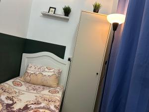 a small bedroom with a bed and a mirror at Private Partition Room Near Mashreq Metro in Dubai