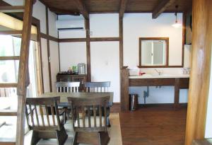 a dining room with a table and chairs and a sink at 天然温泉！古民家風の貸切り一軒家 【白山リバーサイドコテージ 】2-120号棟 in Nihongi