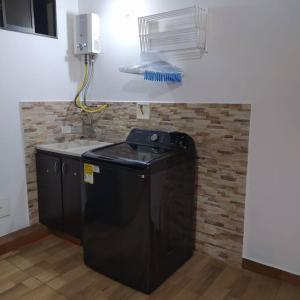 a kitchen with a black dishwasher in a room at Hermoso apartamento en Medellín in Medellín