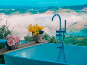 two baskets of flowers sitting on a table with a view at La Montagne Doi Chang in Ban Huai Khai
