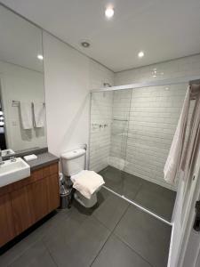 a bathroom with a shower and a toilet and a sink at Pinheiros Duplex no pool in Sao Paulo