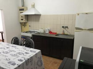 a kitchen with a sink and a stove at departamento cucú in Villa Carlos Paz +4 photos