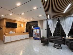 a lobby with a counter and chairs and a bar at ARK House in Phnom Penh