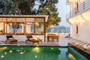 a villa with a swimming pool and a house at The Experience Resort-Lake Facing in Udaipur