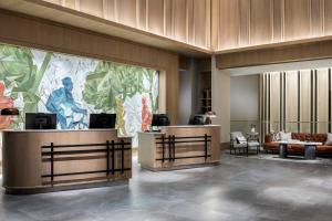 a lobby with a large painting on the wall at Marriott Dallas Uptown in Dallas