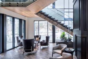a lobby with chairs and stairs in a building at Marriott Dallas Uptown in Dallas
