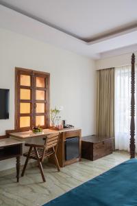a living room with a desk and a tv at The Experience Resort-Lake Facing in Udaipur