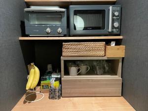 a microwave and a toaster oven on a shelf at Kungin Bettei - Vacation STAY 14605 in Himeji