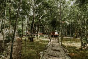 a tree house in the middle of the forest at K NAJ Community Tulum in Balcheil