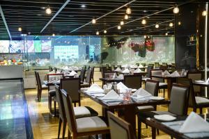 a restaurant with tables and chairs in a room at Wyndham Grand Plaza Royale Ningbo in Ningbo