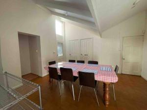 a large room with a table and chairs in it at Group house with views of the salt pool and spa in Mitcham
