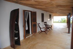 a living room with two chairs and a mirror at Villa Palissandre in Nosy Be