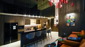 a restaurant with a bar with stools and a counter at ST Signature Bugis Middle,DAYUSE,9 hours 9AM-6PM in Singapore