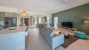 a living room with a blue couch and a table at Blue Nest by Horizon Holidays in Pointe d'Esny