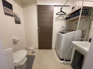 a small bathroom with a sink and a refrigerator at Oak Stay Shimokitazawa Luxury Family size 2min Shimokitazawa sta Shinjuku Shibuya7min by train in Tokyo +82 photos