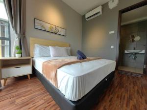a bedroom with a large bed and a sink at Near Airport K Avenue Family Room in Donggongon