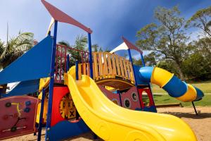 a playground with a slide in a park at BIG4 Wallaga Lake Holiday Park in Bermagui