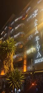 a building with a sign on the side of it at Aria Riva Apart Hotel in Alanya