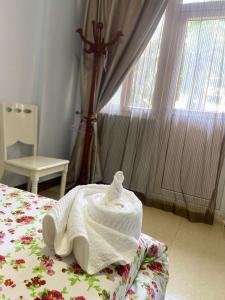 a white towel on a bed in a bedroom at Beachfront M. A.apartment in Dar es Salaam