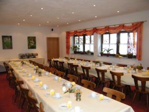 a large room with tables and chairs in it at Weinhaus Berg in Bremm