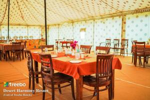 a dining room with a table in a tent at Treebo Trend Desert Harmony Resort in Sām