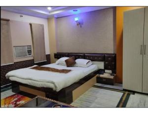 a bedroom with a large bed in a room at Hotel Somraj Regency, Tripura in Agartala