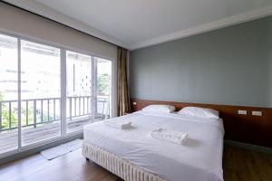 Postel nebo postele na pokoji v ubytování Wong Amat House