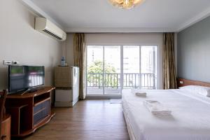 Postel nebo postele na pokoji v ubytování Wong Amat House