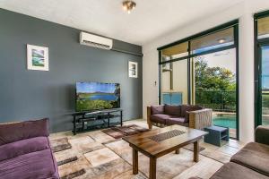 a living room with a couch and a table at A Perfect Stay - Above Byron in Byron Bay