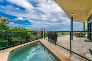 a swimming pool on the balcony of a house at A Perfect Stay - Above Byron in Byron Bay