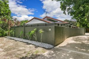 a fence in front of a house at A Perfect Stay - At the Beach in Suffolk Park