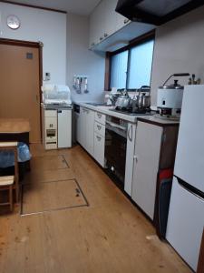 a kitchen with white counters and a stove top oven at Bayside House Shiosai - Vacation STAY 15343 in Kumano
