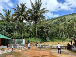 a group of people playing a game of baseball at Sherlock Jungle Retreat in Srimangala