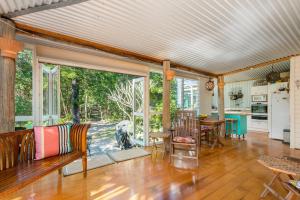 a living room with a couch and a table at A Perfect Stay - Beachcombers Cottage in Suffolk Park