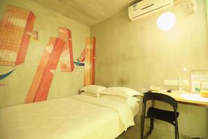 Habitación hospitalaria con cama y escritorio en Colour Inn - She Kou Branch, en Shenzhen