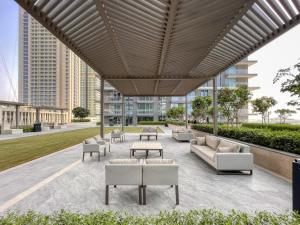 a patio with couches and tables in a building at Sea view 2-Bedroom - Beach Isle in Dubai