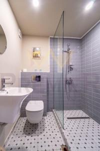 a bathroom with a shower and a toilet and a sink at Casa Verde in Saints Constantine and Helena