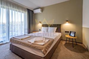 a hotel room with a large bed and a window at Casa Verde in Saints Constantine and Helena