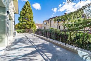 a fence on a sidewalk next to a building at Casa Verde in Saints Constantine and Helena